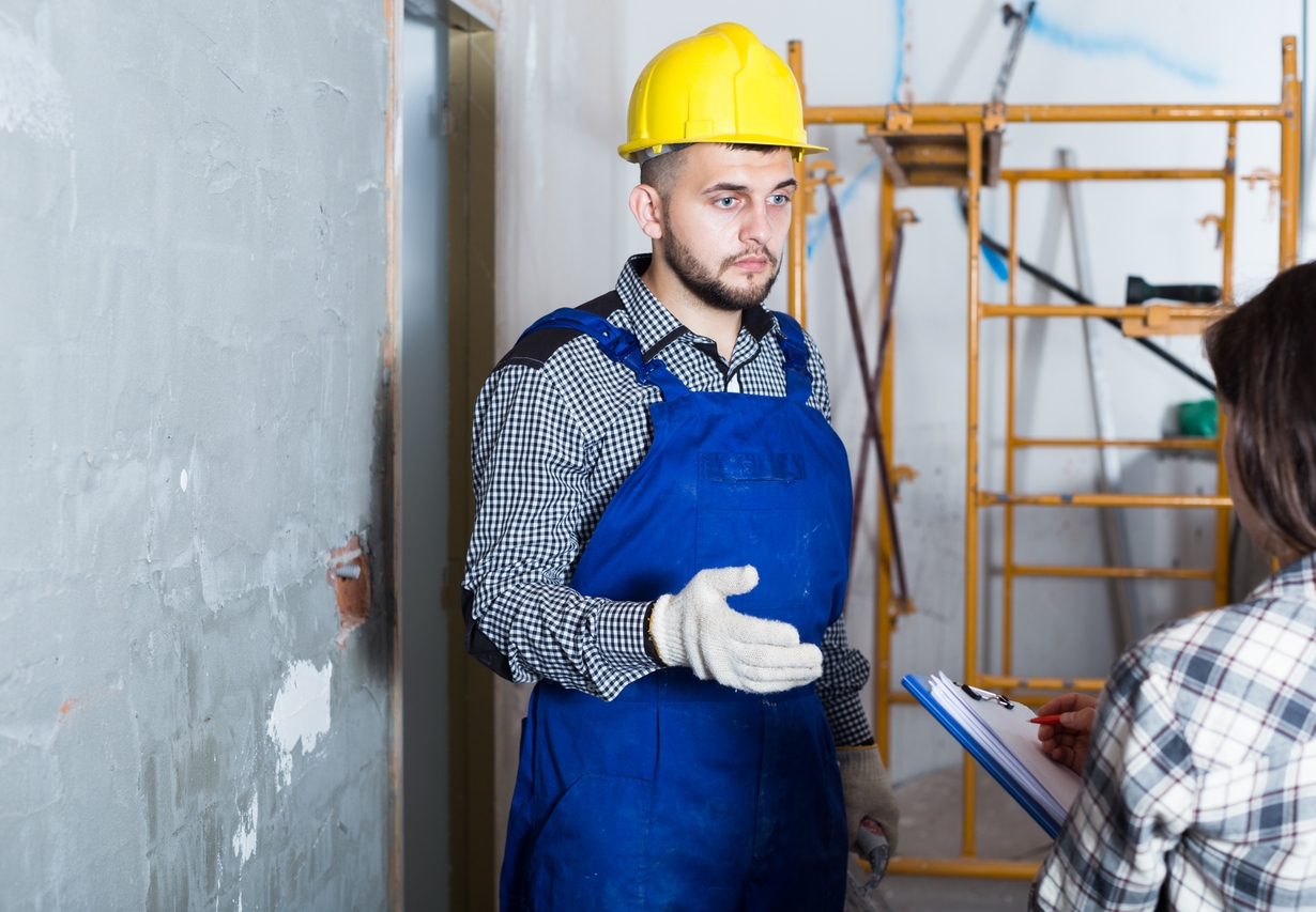 Professional worker with spatula is talking to client