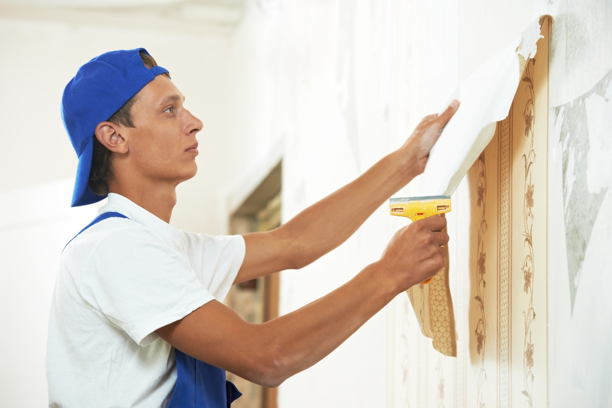 Professional Painter peeling off wallpaper in a Tracy area home